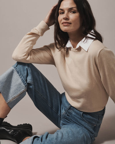 Model wearing our unisex extra-fine merino wool crew neck jumper, made from a lightweight fabric and reactive natural fibre. Ideal for layering under our waterproof dry robes for city commute or layering up for a friend's BBQ in the evening. The perfect addition to any minimalist capsule wardrobe.