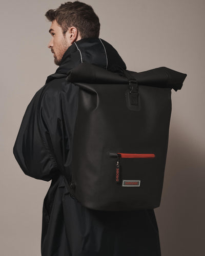 Model wearing our roll-top rucksack with our waterproof dry robe. It is a must-have for any sport Robe wearer, commuter and traveller. Made from durable, waterproof and sustainable TPU and fitted with extra storage.