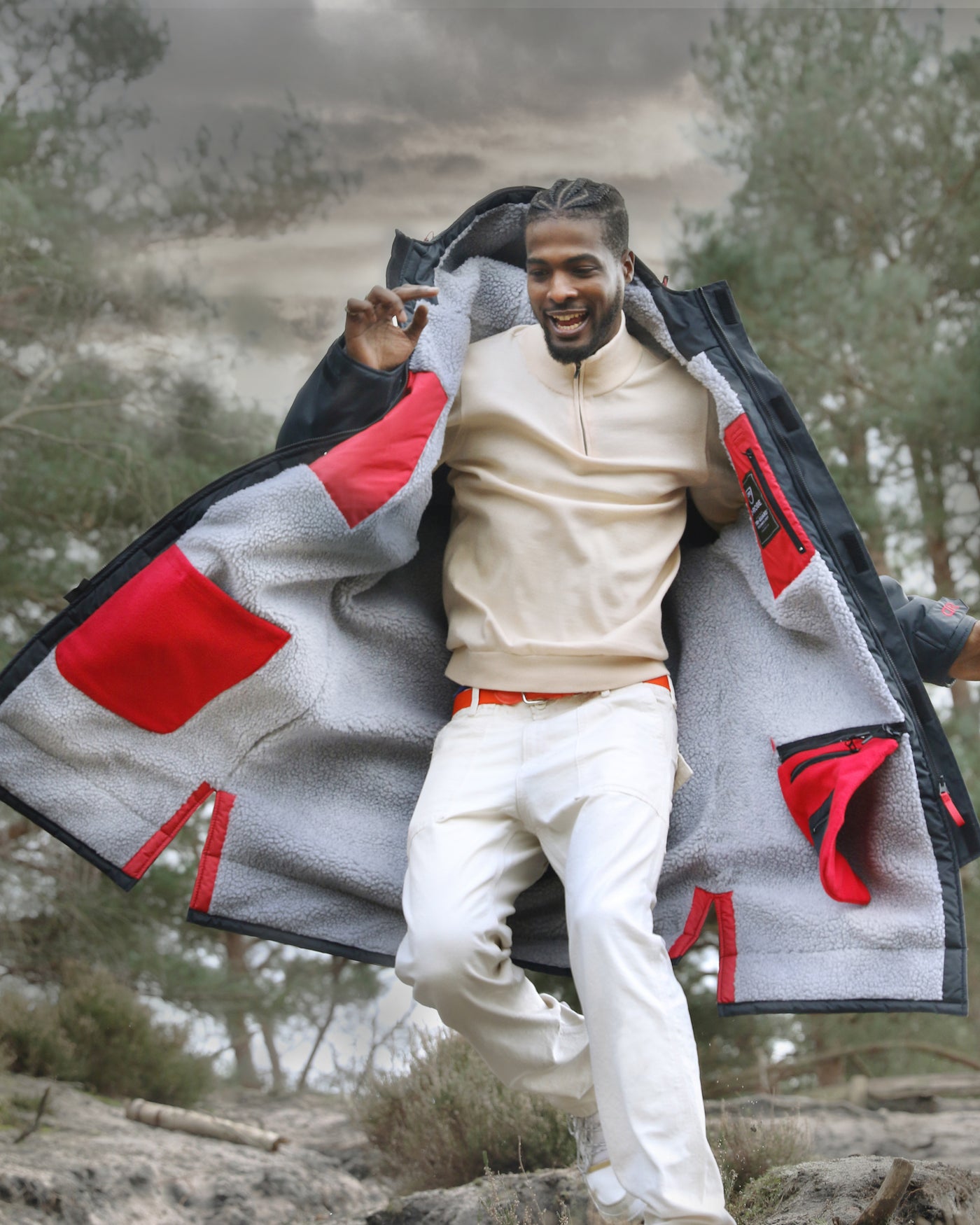 Male on a walk in the woods wearing a stylish waterproof jacket that is full length and fleece-lined. You can wear these outdoor robes for walking the dog, watching rugby and football, extreme sports, cold water swimming, surfing. They are both functional and stylish robes, the indispensable piece for any capsule wardrobe.